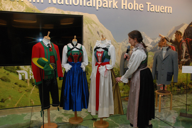 Der seidene Rock der Pustertaler Hochzeitstracht soll mit seiner goldenen Farbe Reichtum demonstrieren, erklärt Schneidermeisterin Marianna Oberdorfer. Im Hintergrund der moderne Osttirol-Walker (r.).