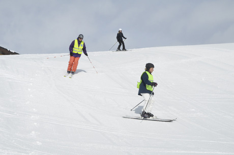 Die Vibrationsfernbedienung hat Sofia beim Skifahren am Handgelenk.